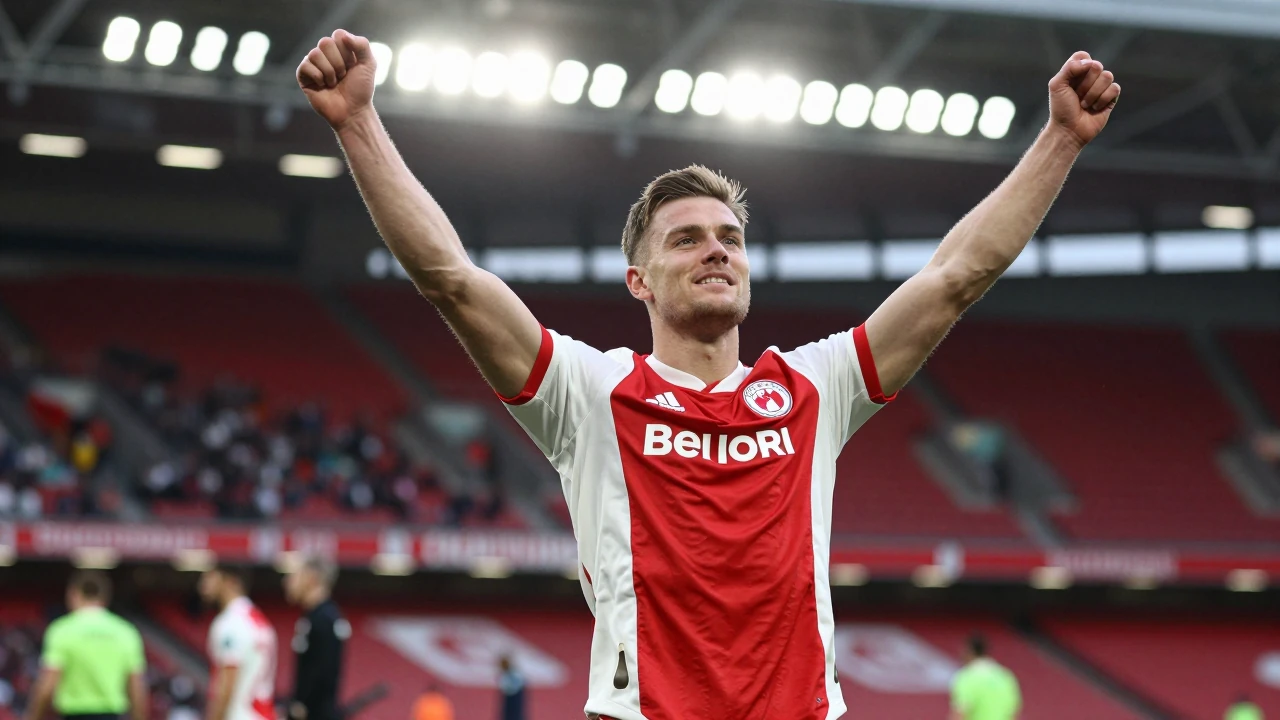 Waist-up shot of an anonymous Barrow AFC player in a red and white striped jersey, head-and-shoulders, celebrating with...