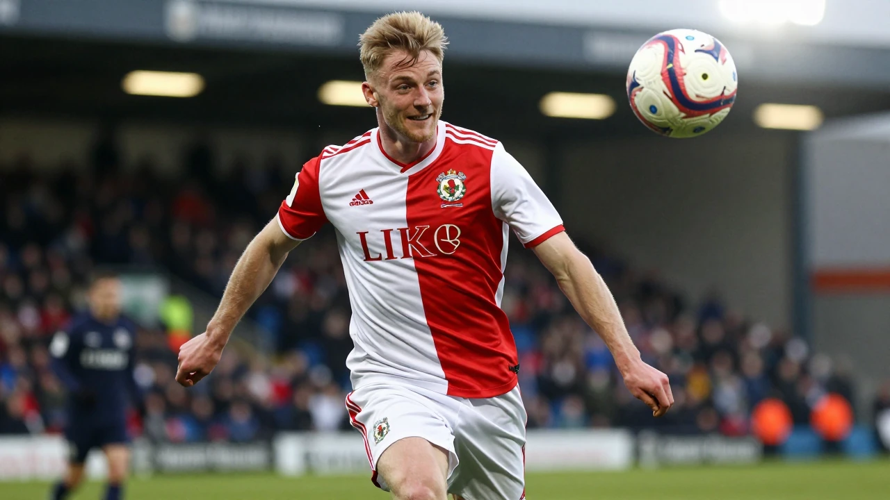Floodlight rim light: A robust young forward in Shamrock Rovers' red and white strip strides confidently down the wing...