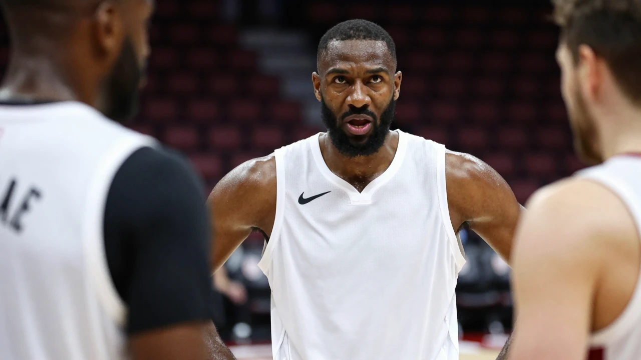 A 6'9" power forward in a plain white Miami Heat training top, his broad shoulders squared, face flushed with intensity...