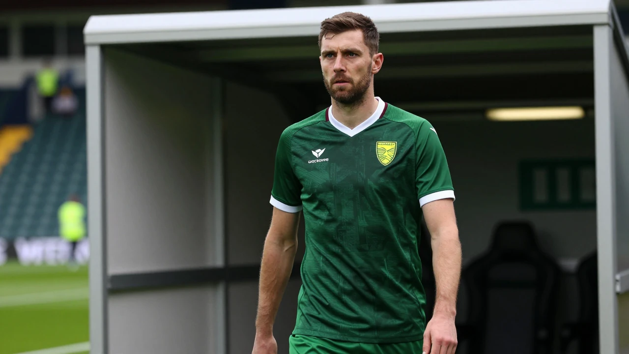 A medium shot of a 35-year-old, 5'10" male coach, wearing Norwich City's home kit of a dark green shirt with a white...