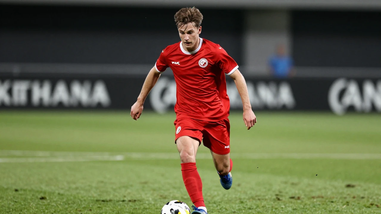 Energetic KV Mechelen attacker in bright red kit, shoulders hunched, eyes focused and determined, about 22 years old...