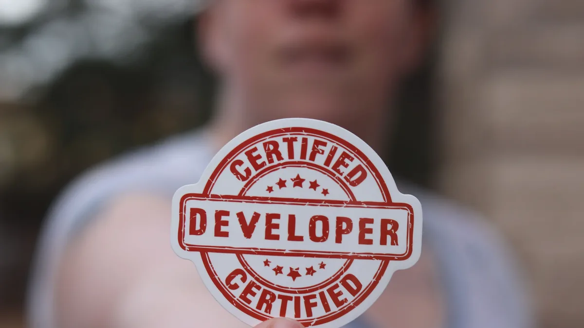Film: Close-up of a certified developer badge being held outdoors.