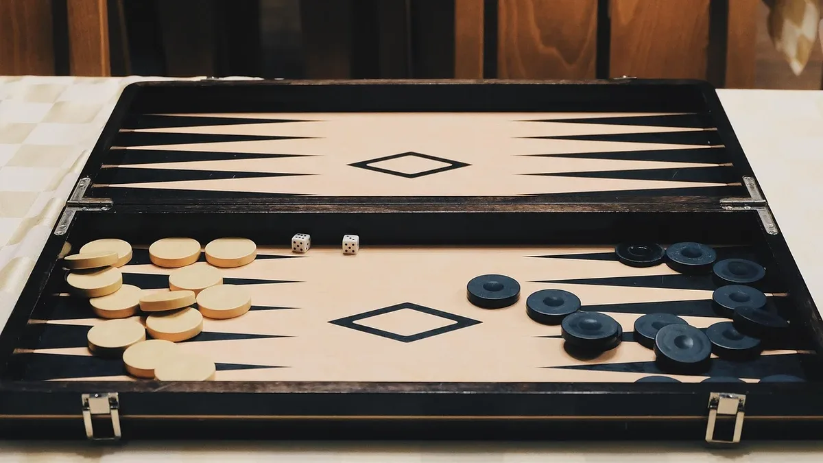 The Scene: A backgammon board with pieces and dice on a table.