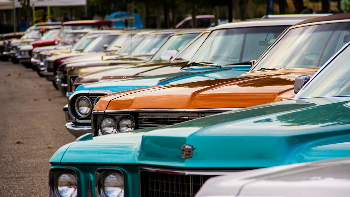 Restoration: A row of classic vintage cars displayed outdoors.