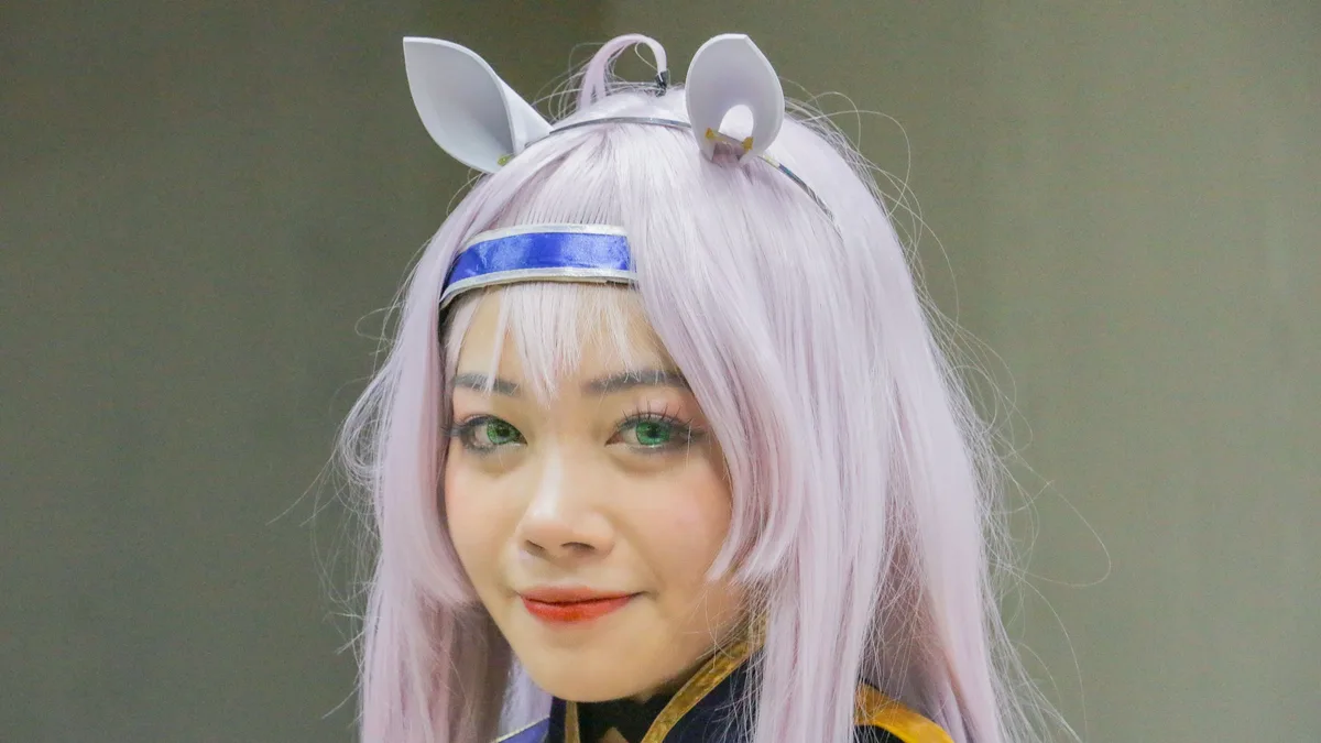 Source Material: Close-up portrait of an anime cosplayer with pastel hair and vibrant costume. Anime close up