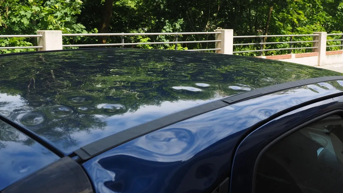 Response: Hail damage, automobile, car roof, paint damage, bumps, dents.
