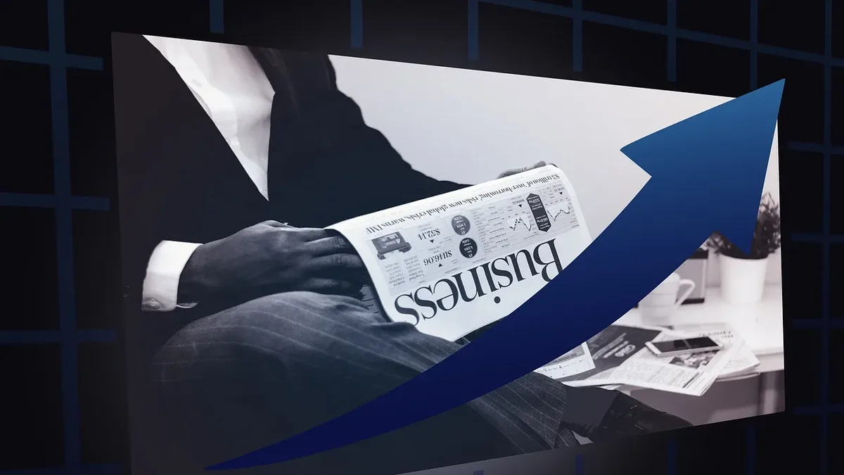 Funding: A person sitting at a desk, reading a newspaper with the word "business" on the front page.