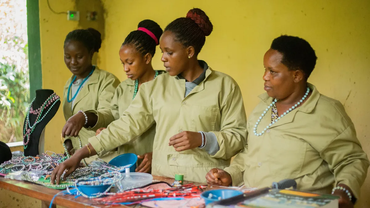 Running: Four women working together on beaded jewelry in a workshop. Entrepreneurship equipment