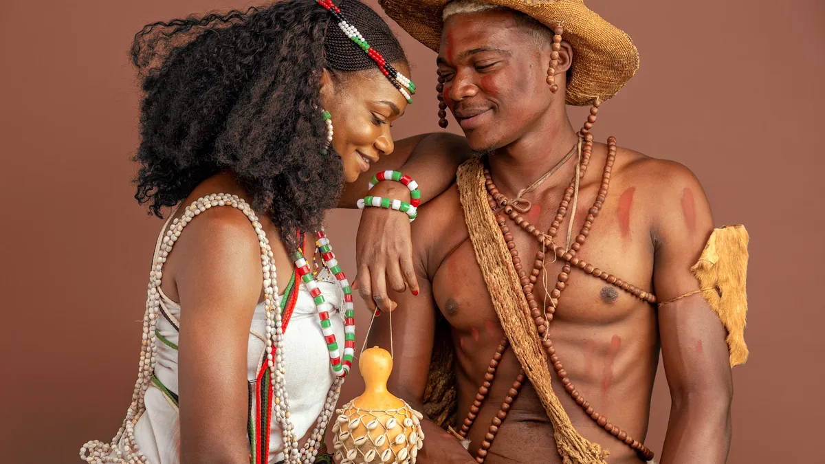 Arts Institutions: A couple in traditional African clothing sharing a joyful moment, showcasing rich cultural heritage.