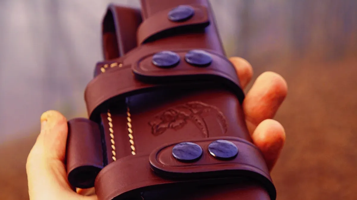 A guide on finishing a custom leather tool scabbard, covering edge trimming, hole punching, and setting solid copper...