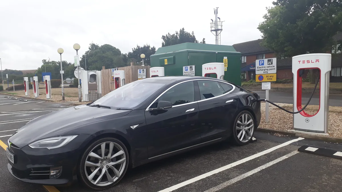 A prototype of Porsche's upcoming electric Boxster was photographed using a Tesla Supercharger in California, indicating...