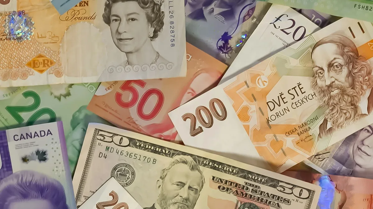 A collection of banknotes from various countries, including the United States, Canada, and the United Kingdom, featuring
