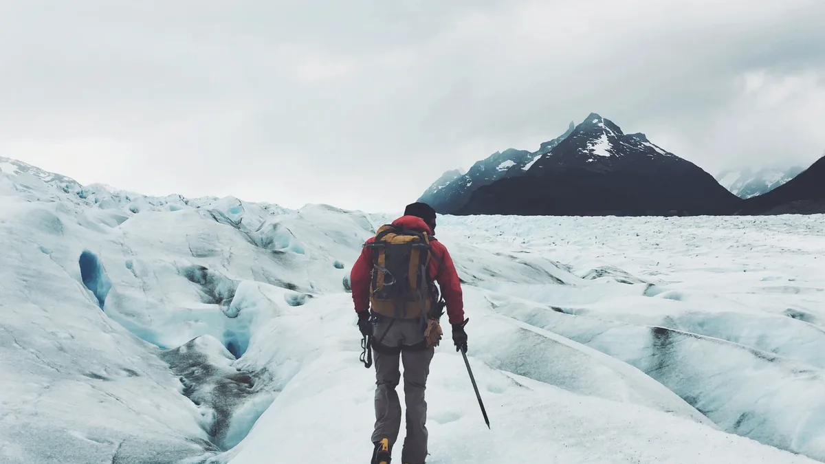 A Continental Divide Trail hiker endures relentless rain, hail, and fierce winds while crossing a high pass in Glacier...