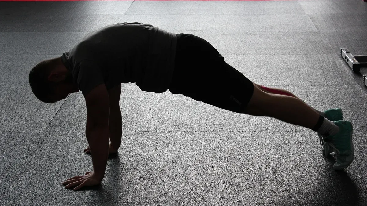 A fitness expert explains the monk plank challenge, an advanced core exercise requiring significant mobility and stability