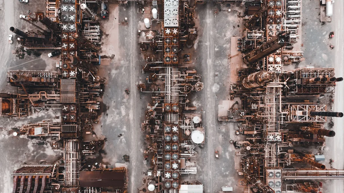 Drinks: An aerial view of a large industrial facility with numerous pipes, tanks, and machinery.