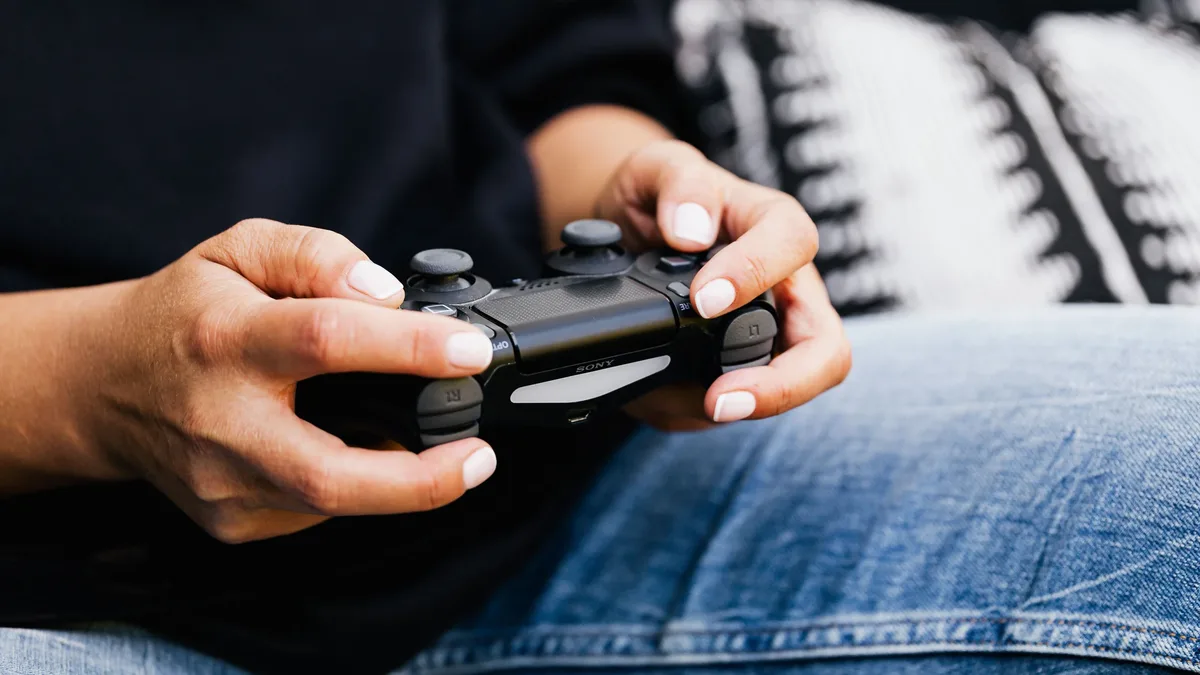 Pricing: A person playing video games with a close-up of their hands holding a gaming controller.