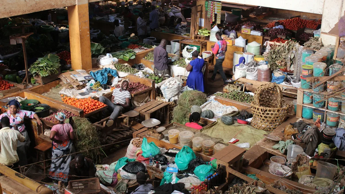 Regulation: A bustling marketplace with numerous vendors and customers, showcasing a variety of goods and produce.