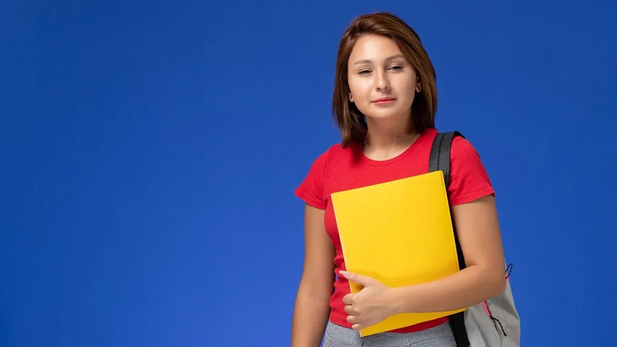 Student Life: Girl, student, backpack, yellow folder, blue background, smile.