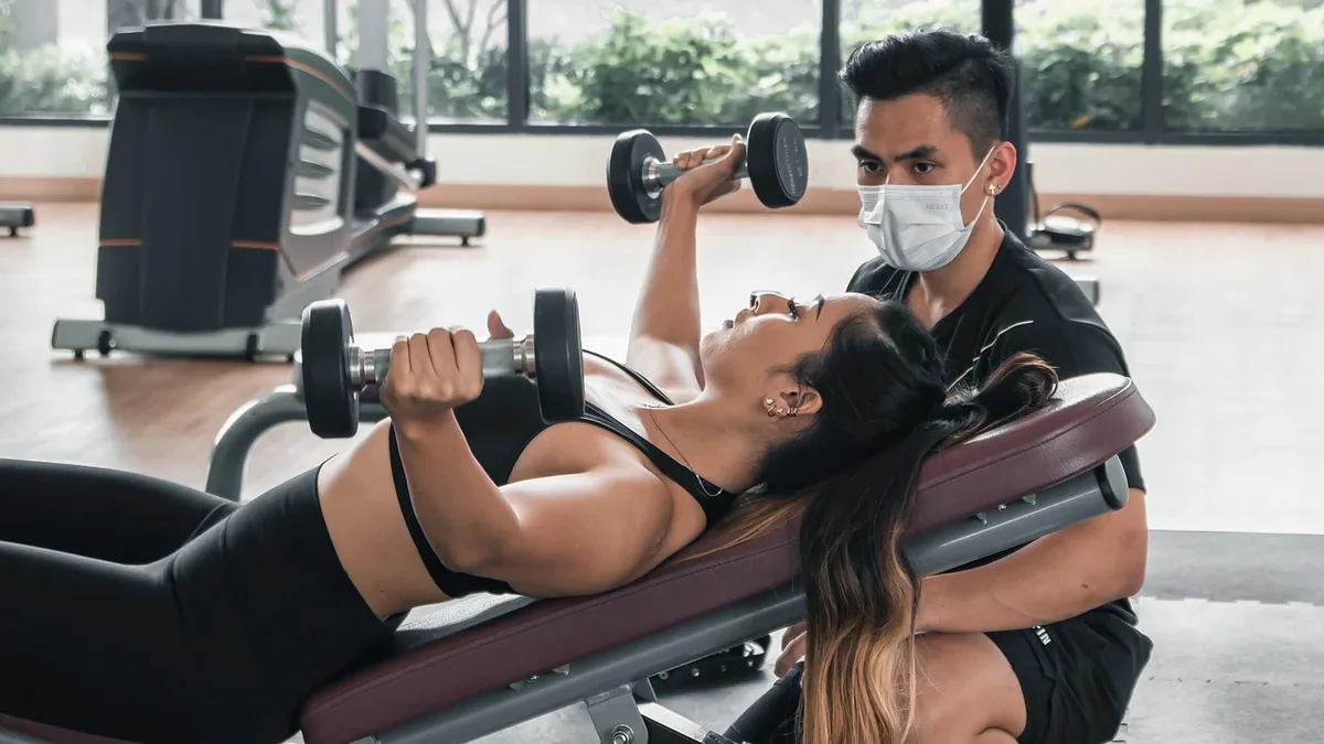 Dave Bautista uses a modified preacher curl bench to lock his upper arm in place, ensuring only the biceps move during...
