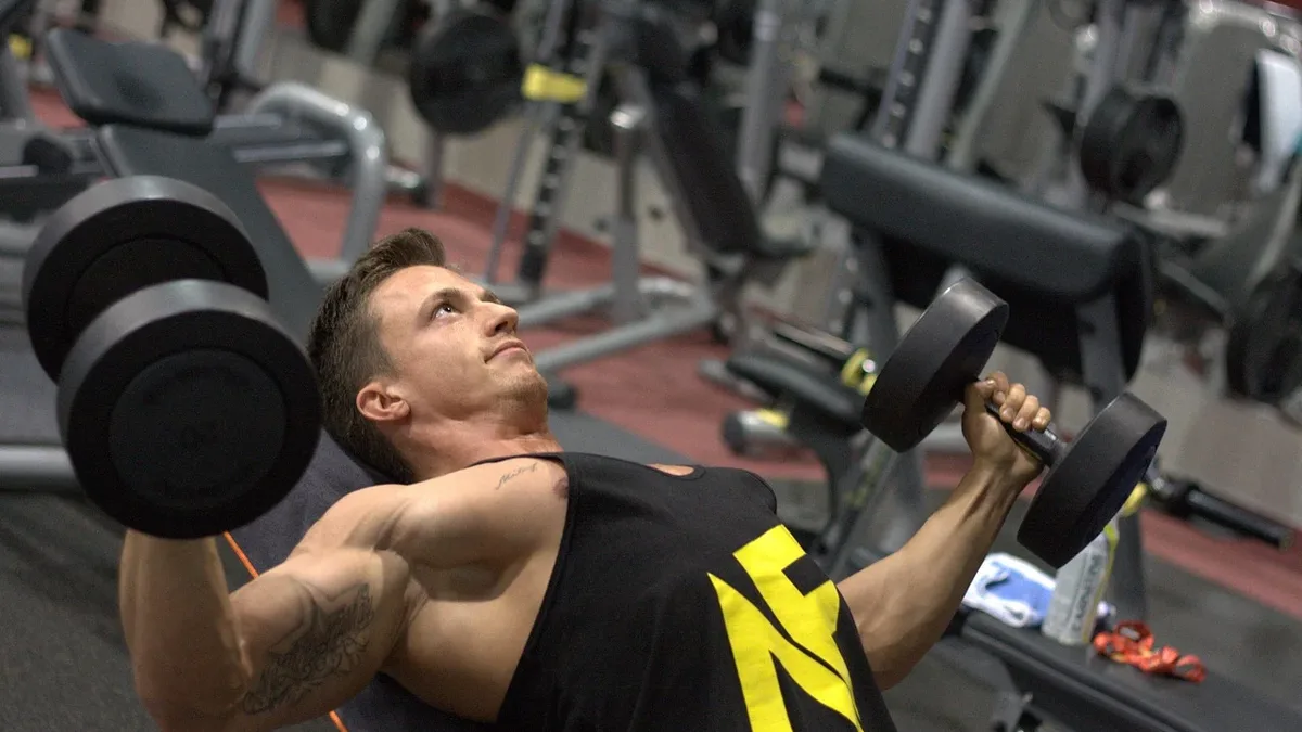 The dumbbell floor press, performed lying on the floor, limits range of motion to ease shoulder strain while effectively...
