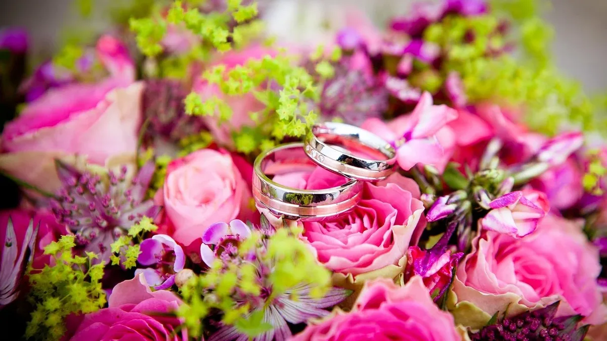 A couple celebrates their spring wedding with a 'Garden Party by the Sea' theme, featuring pink and green floral motifs, a...