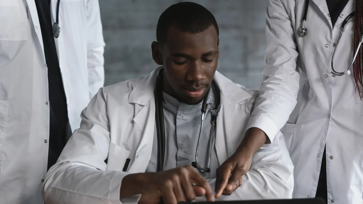 Sectors: Doctors in discussion over a medical research project in a clinical setting.