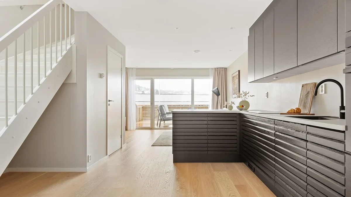 A kitchen designer details how a client's space uses color, open storage, and a vintage island to achieve an eclectic...