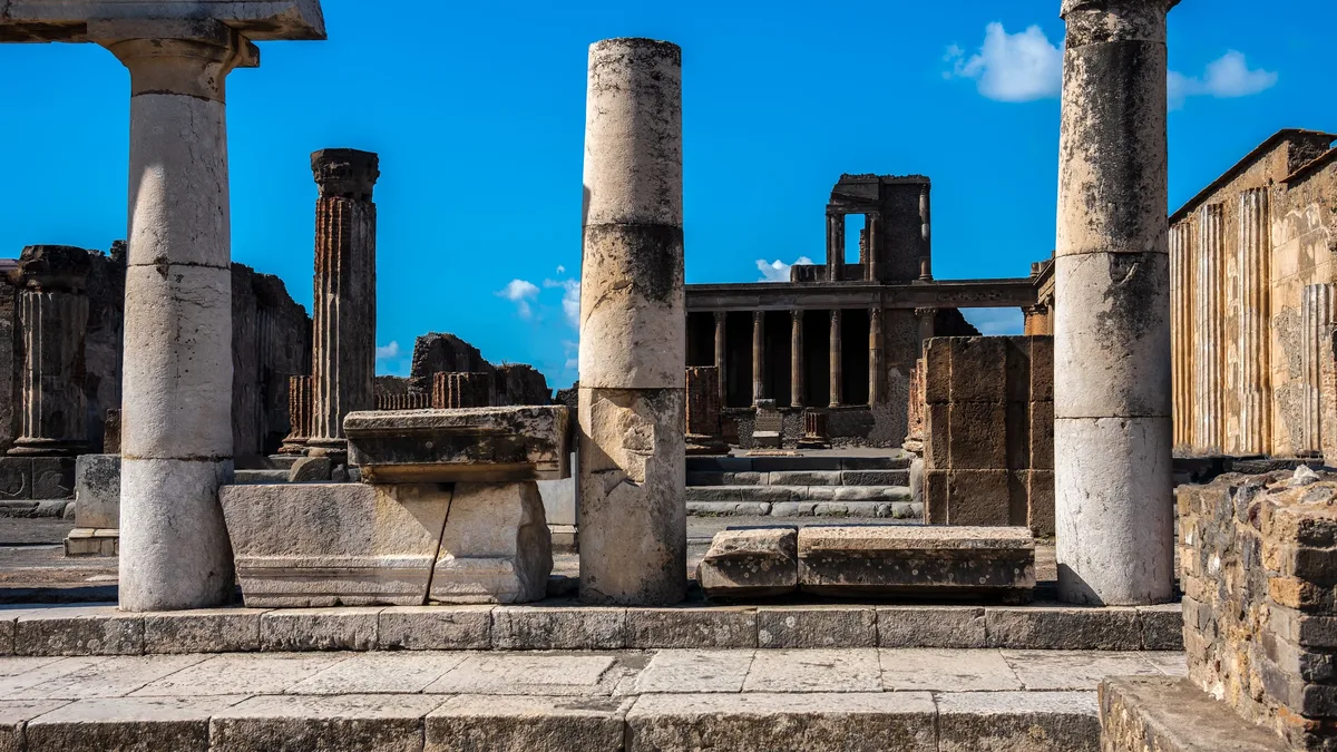 Finds Material: Explore the well-preserved ruins of ancient Pompeii featuring classic stone columns.