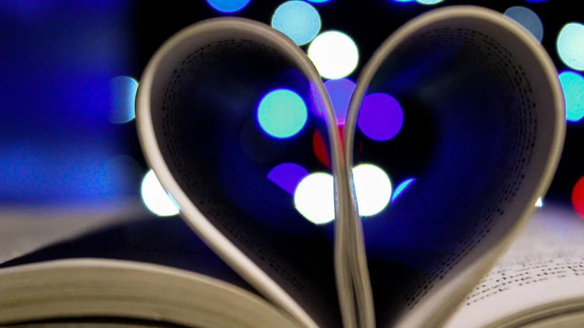 Reading Life: Book pages shaped into a heart with vibrant lighting effects.