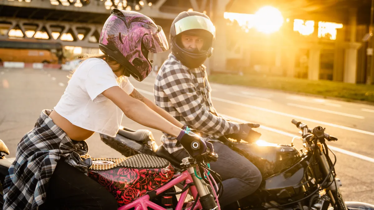 A couple on motorcycles enjoying a city ride during a beautiful sunset, capturing adventure and lifestyle. Motorcycles
